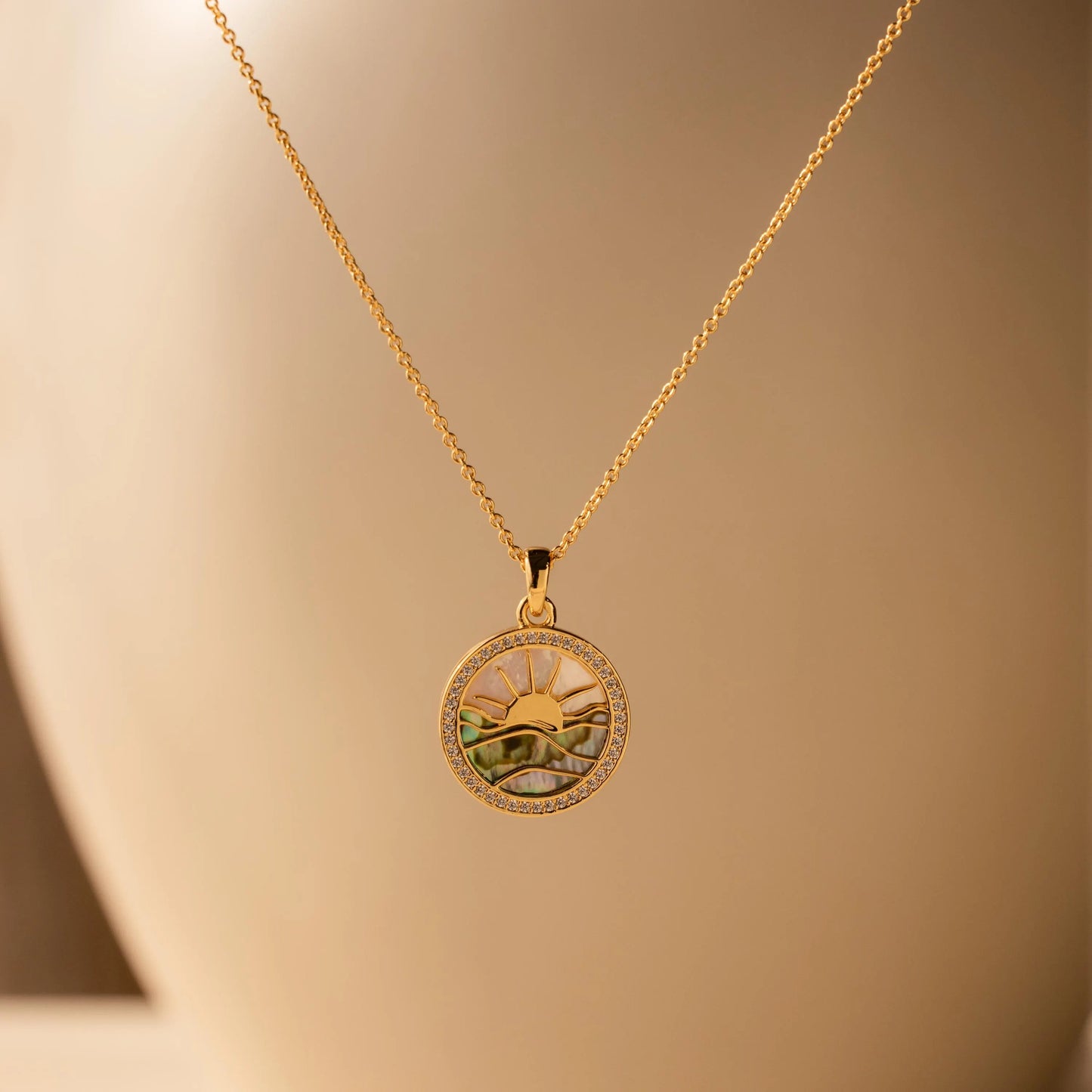 An 18-carat gold sunrise necklace, handcrafted from abalone and pearls